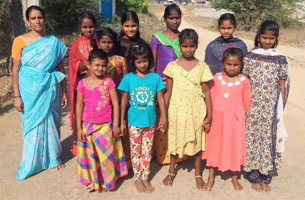 Orphan overseer Ebenezer Paul with the orphans in Vinyaka Puram Village, India.